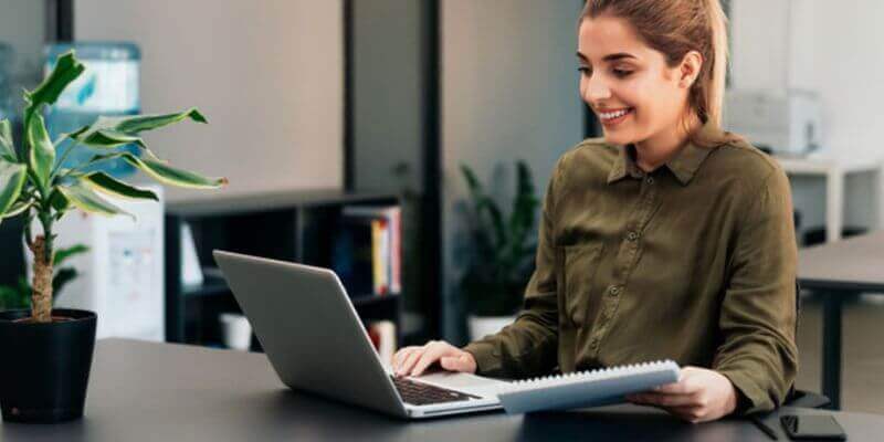 Women Marketer in Dark green shirt working on laptop