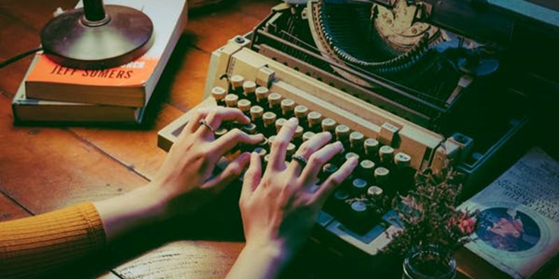 Hands of man typing on a typewriter